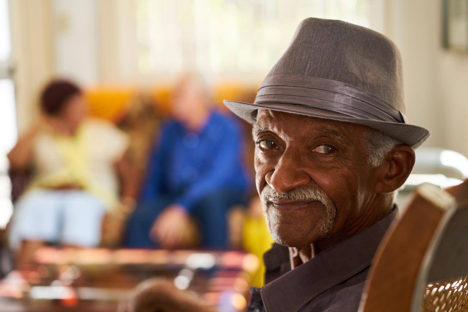 Older man sitting in an assisted care facility